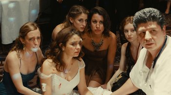 Movie still from “Wild Tales” (2014), directed by Damián Szifron – A group of women sitting next to each other; Medium shot, High angle