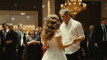 Movie still from “Wild Tales” (2014), directed by Damián Szifron – A man and a woman dancing in front of a crowd; Medium shot, Over the shoulder angle