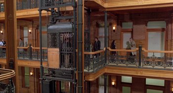 Movie still from “Wolf” (1994), directed by Mike Nichols – People are standing on the balcony of a building; Extreme Wide shot, High angle