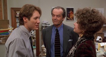 Movie still from “Wolf” (1994), directed by Mike Nichols – Two men and a woman standing in front of a wall; Medium shot, Over the shoulder angle