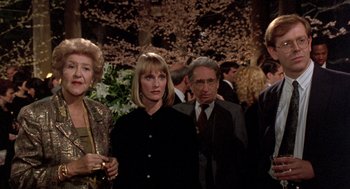 Movie still from “Wolf” (1994), directed by Mike Nichols – A group of people standing next to each other in a room; Medium shot, Over the shoulder angle