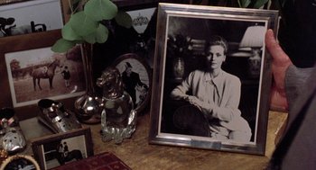 Movie still from “Wolf” (1994), directed by Mike Nichols – An old photo of a woman sitting on a chair; Extreme Close Up shot, High angle