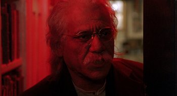 Movie still from “Wolf” (1994), directed by Mike Nichols – An old man with a beard and mustache wearing glasses; Close Up shot, Low angle