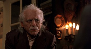 Movie still from “Wolf” (1994), directed by Mike Nichols – An older man with white hair and glasses; Close Up shot, Low angle