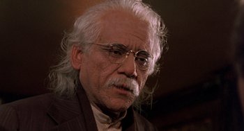 Movie still from “Wolf” (1994), directed by Mike Nichols – An older man with white hair wearing glasses; Close Up shot, Low angle
