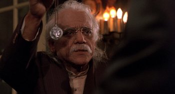 Movie still from “Wolf” (1994), directed by Mike Nichols – An old man with white hair and glasses; Close Up shot, High angle