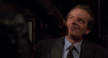 Movie still from “Wolf” (1994), directed by Mike Nichols – A man in a suit and tie looking up; Close Up shot, Over the shoulder angle