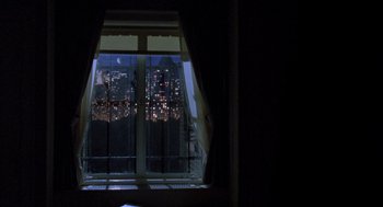 Movie still from “Wolf” (1994), directed by Mike Nichols – A view of a city at night through a window; Extreme Wide shot, High angle