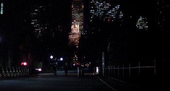 Movie still from “Wolf” (1994), directed by Mike Nichols – People are walking down the sidewalk at night; Extreme Wide shot, High angle