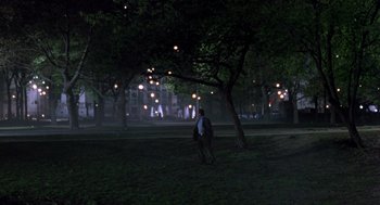Movie still from “Wolf” (1994), directed by Mike Nichols – A man standing in the middle of a park at night; Extreme Wide shot, High angle