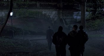 Movie still from “Wolf” (1994), directed by Mike Nichols – A group of people walking down a street at night; Wide shot, Over the shoulder angle