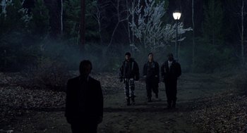 Movie still from “Wolf” (1994), directed by Mike Nichols – A group of people walking in the woods at night; Wide shot, Low angle