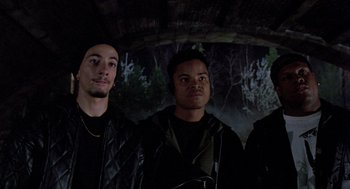 Movie still from “Wolf” (1994), directed by Mike Nichols – A group of men standing next to each other in front of trees; Medium shot, Low angle