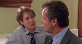 Movie still from “Wolf” (1994), directed by Mike Nichols – A man in a suit talking to another man in a dress shirt; Close Up shot, Over the shoulder angle