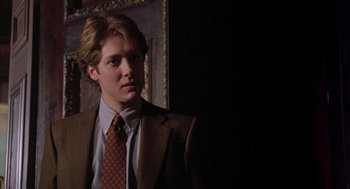 Movie still from “Wolf” (1994), directed by Mike Nichols – A man in a suit and tie standing in front of a mirror; Close Up shot, Low angle