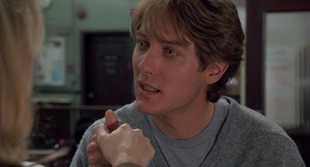Movie still from “Wolf” (1994), directed by Mike Nichols – A young man holding his hand up to his face; Close Up shot, Over the shoulder angle