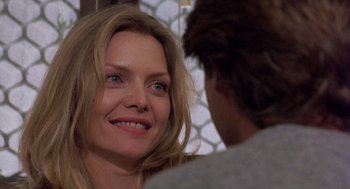 Movie still from “Wolf” (1994), directed by Mike Nichols – A person smiling at the camera; Close Up shot, Over the shoulder angle