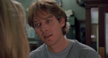 Movie still from “Wolf” (1994), directed by Mike Nichols – A person wearing a gray shirt; Close Up shot, Over the shoulder angle