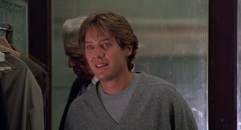 Movie still from “Wolf” (1994), directed by Mike Nichols – A young man in a gray shirt is looking at the camera; Close Up shot, Over the shoulder angle