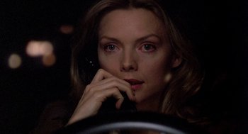 Movie still from “Wolf” (1994), directed by Mike Nichols – A woman sitting in a car while talking on the phone; Close Up shot, High angle