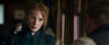 Movie still from “Woman Walks Ahead” (2017), directed by Susanna White – A person wearing a green shirt; Close Up shot, Over the shoulder angle