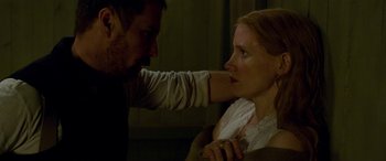 Movie still from “Woman Walks Ahead” (2017), directed by Susanna White – A man and a woman touching each other's neck; Close Up shot, Over the shoulder angle