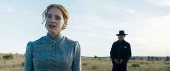 Movie still from “Woman Walks Ahead” (2017), directed by Susanna White – A woman standing next to a man in a field; Medium shot, Over the shoulder angle