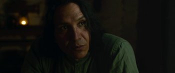 Movie still from “Woman Walks Ahead” (2017), directed by Susanna White – A person with long hair is looking at the camera; Close Up shot, Low angle