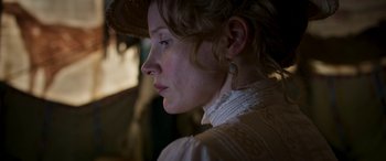 Movie still from “Woman Walks Ahead” (2017), directed by Susanna White – A person wearing a hat; Close Up shot, Low angle