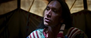 Movie still from “Woman Walks Ahead” (2017), directed by Susanna White – A person holding a wooden stick; Close Up shot, Over the shoulder angle