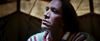 Movie still from “Woman Walks Ahead” (2017), directed by Susanna White – A person wearing a striped shirt; Close Up shot, Low angle