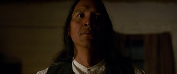 Movie still from “Woman Walks Ahead” (2017), directed by Susanna White – A person with long black hair; Close Up shot, Low angle