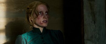 Movie still from “Woman Walks Ahead” (2017), directed by Susanna White – A young woman with red spots on her face; Close Up shot, Over the shoulder angle