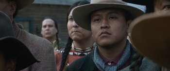 Movie still from “Woman Walks Ahead” (2017), directed by Susanna White – A group of native american men standing next to each other; Close Up shot, Over the shoulder angle