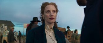 Movie still from “Woman Walks Ahead” (2017), directed by Susanna White – A woman in a white shirt and a blue jacket; Close Up shot, Low angle