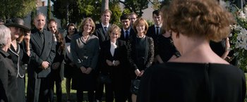 Movie still from “Woman in Gold” (2015), directed by Simon Curtis – A group of people standing in front of a tree; Medium shot, Over the shoulder angle