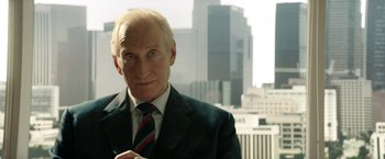 Movie still from “Woman in Gold” (2015), directed by Simon Curtis – An older man wearing a suit and tie in front of a city skyline; Close Up shot, Low angle