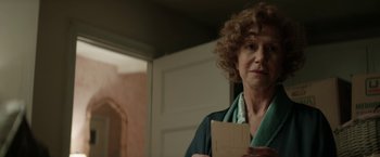 Movie still from “Woman in Gold” (2015), directed by Simon Curtis – A woman standing in front of a door holding a piece of paper; Close Up shot, Over the shoulder angle