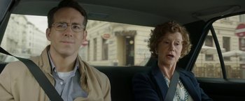 Movie still from “Woman in Gold” (2015), directed by Simon Curtis – A man and a woman sitting in the back of a car; Close Up shot, Over the shoulder angle