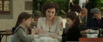 Movie still from “Woman in Gold” (2015), directed by Simon Curtis – A group of people sitting at a table with food; Medium shot, Over the shoulder angle