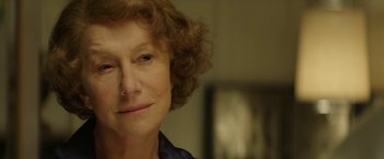 Movie still from “Woman in Gold” (2015), directed by Simon Curtis – An older woman is smiling for the camera; Close Up shot, Over the shoulder angle