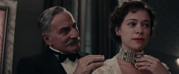 Movie still from “Woman in Gold” (2015), directed by Simon Curtis – An older man and a younger woman in formal wear; Close Up shot, Over the shoulder angle