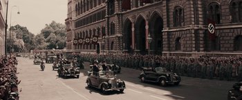 Movie still from “Woman in Gold” (2015), directed by Simon Curtis – An old photo of a parade with a lot of cars; Extreme Wide shot, High angle