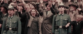 Movie still from “Woman in Gold” (2015), directed by Simon Curtis – A group of people standing next to each other; Medium shot, Low angle