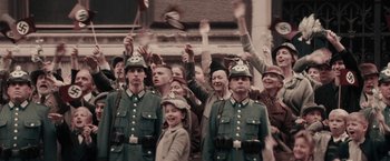 Movie still from “Woman in Gold” (2015), directed by Simon Curtis – A group of men and women in uniforms and hats; Wide shot, High angle