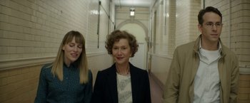 Movie still from “Woman in Gold” (2015), directed by Simon Curtis – A woman in a suit standing next to two other people; Medium shot, Low angle