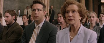 Movie still from “Woman in Gold” (2015), directed by Simon Curtis – A man and a woman in a suit and tie in front of a crowd; Close Up shot, Over the shoulder angle