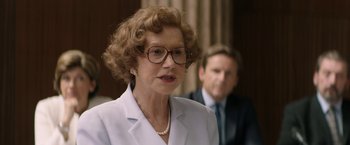 Movie still from “Woman in Gold” (2015), directed by Simon Curtis – An older woman wearing glasses and a white jacket; Close Up shot, Over the shoulder angle