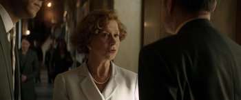 Movie still from “Woman in Gold” (2015), directed by Simon Curtis – An older woman wearing a white suit and a pearl necklace; Close Up shot, Over the shoulder angle