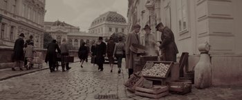 Movie still from “Woman in Gold” (2015), directed by Simon Curtis – A group of people walking down a street; Wide shot, High angle